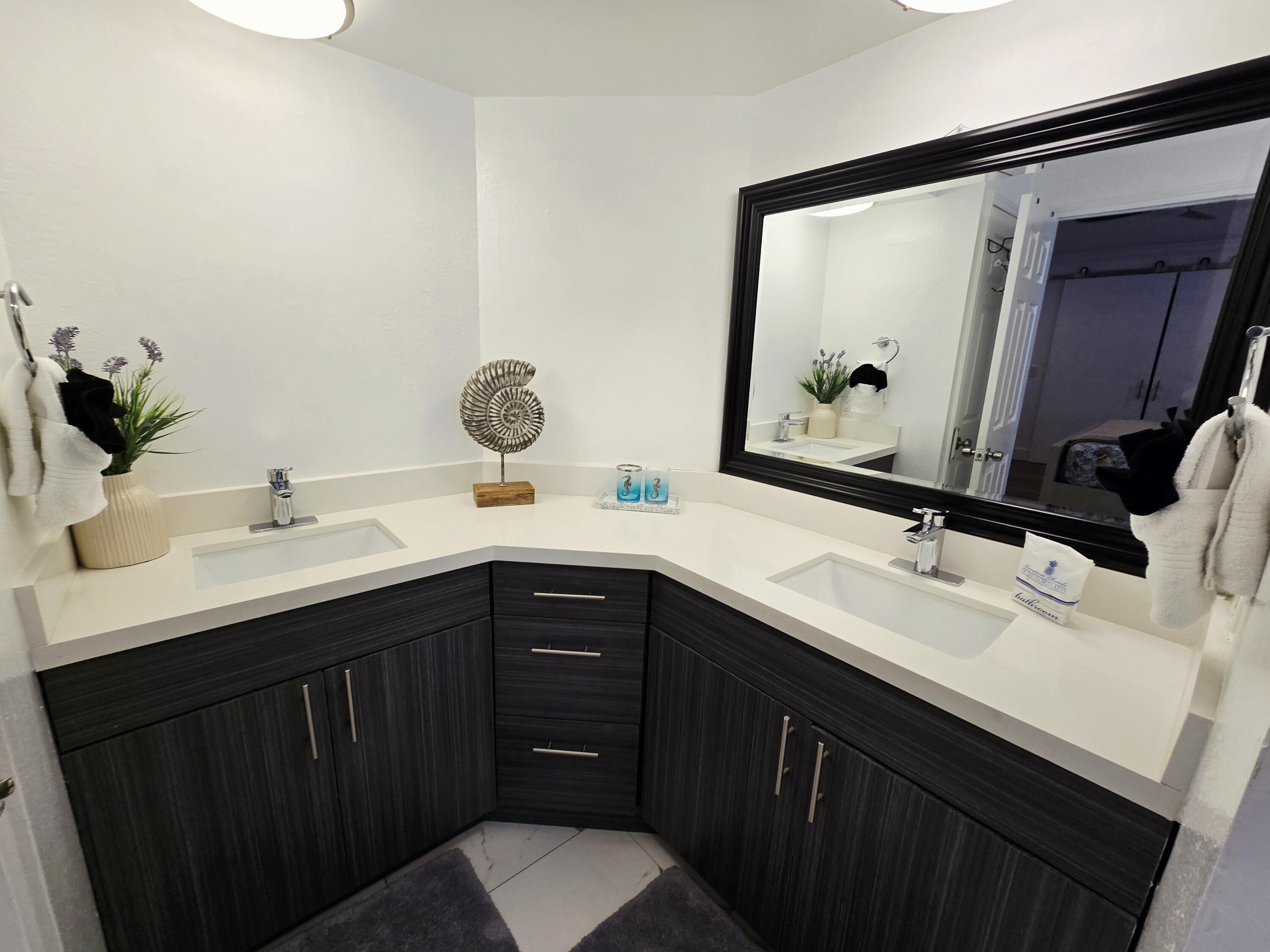 837 91st St Ocean Marathon, FL 33050 - Photo 18 of 27 a bathroom with a sink and a mirror