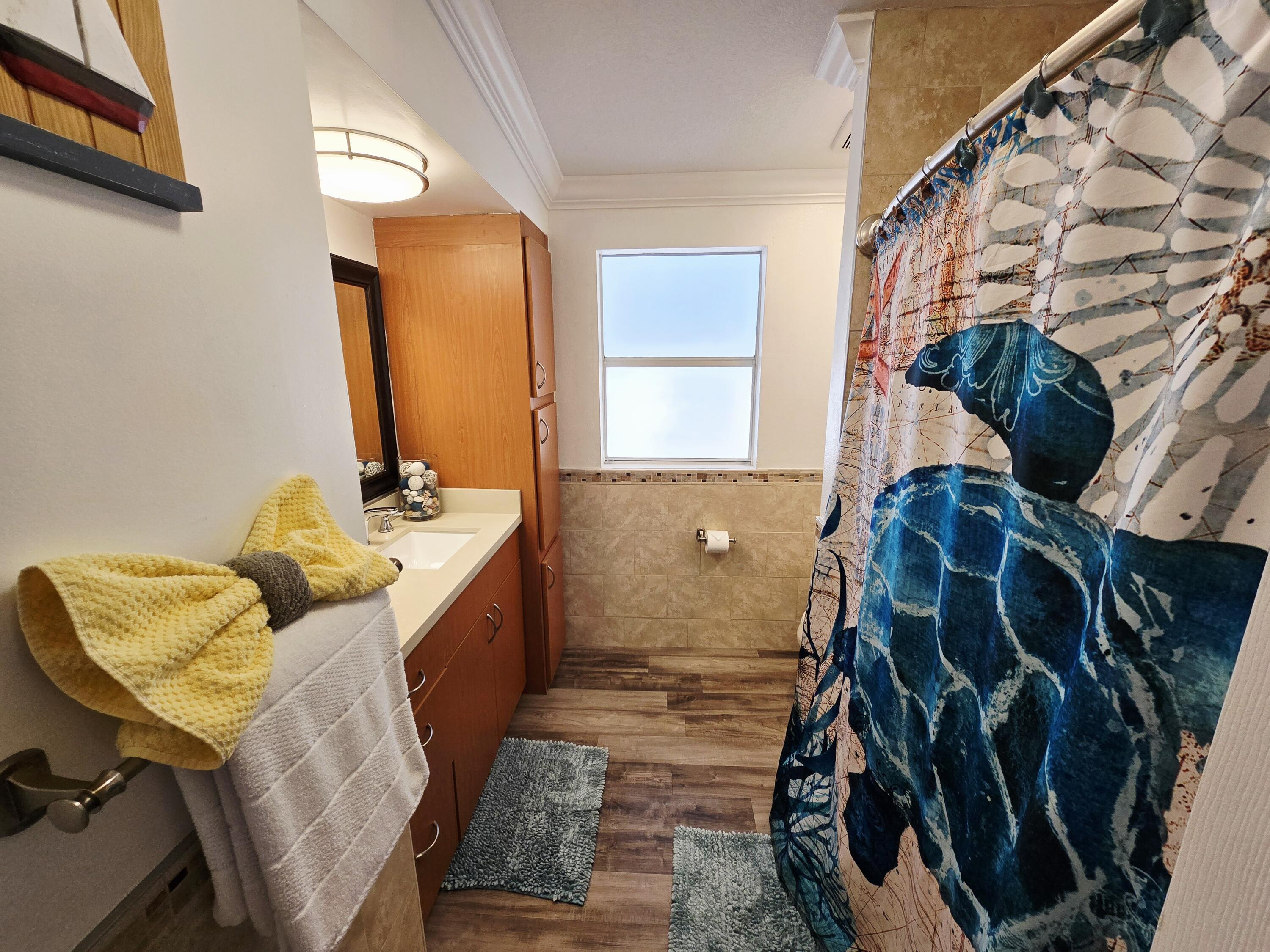 837 91st St Ocean Marathon, FL 33050 - Photo 19 of 27 a bathroom with a tub sink and mirror