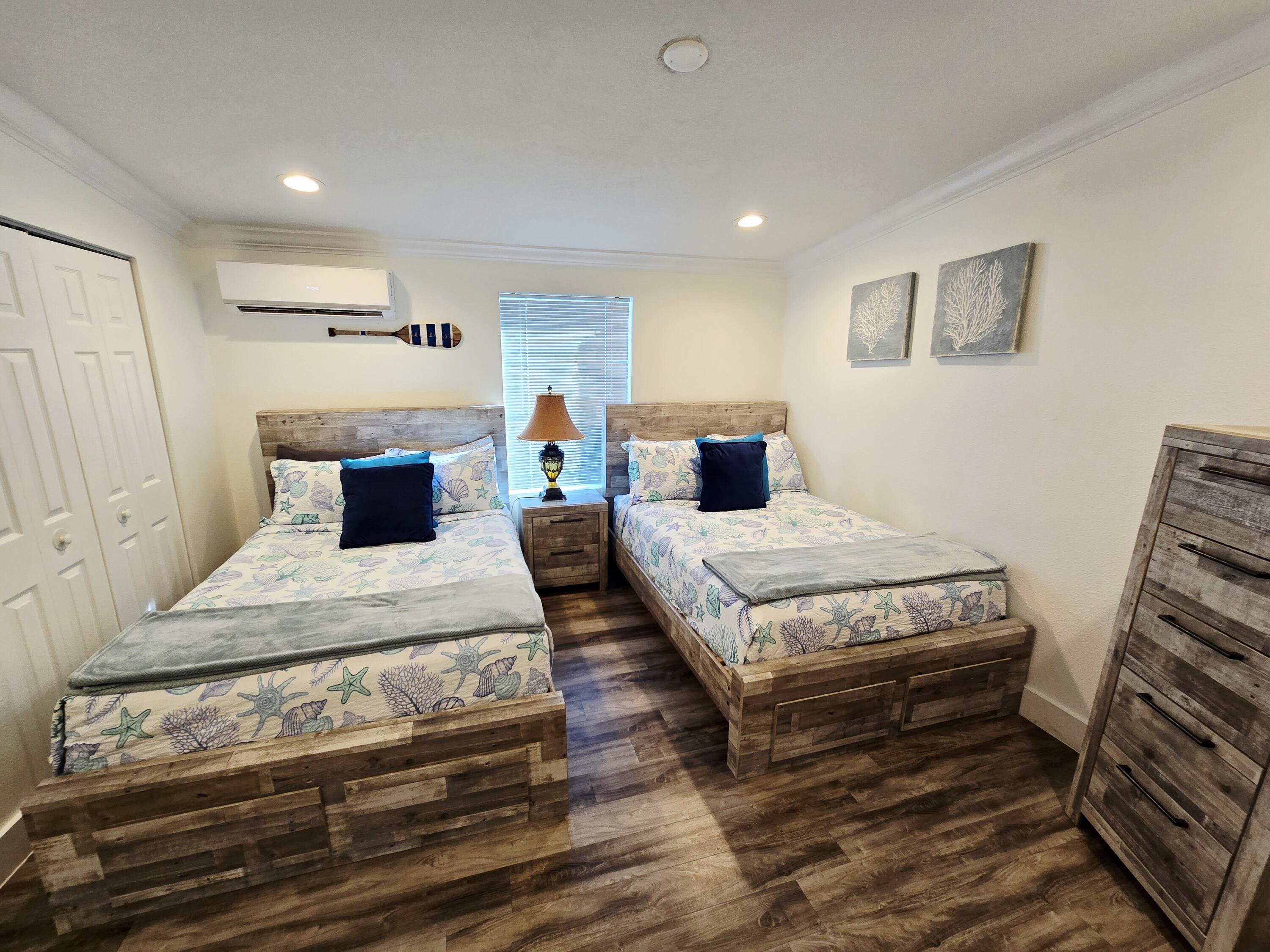 837 91st St Ocean Marathon, FL 33050 - Photo 20 of 27 a bedroom with a bed and wooden floor