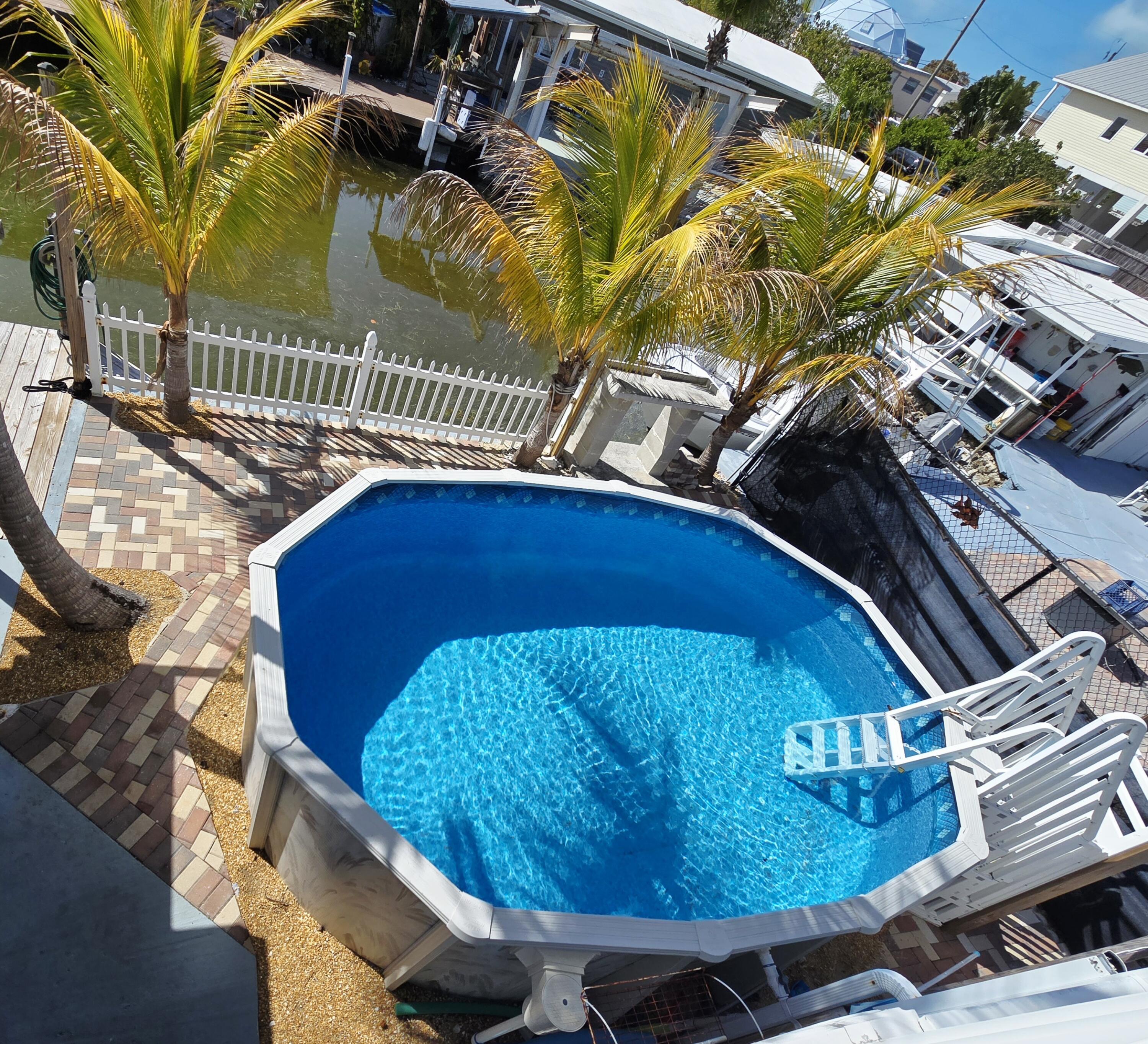 837 91st St Ocean Marathon, FL 33050 - Photo 2 of 27 a view of a chairs and table in the backyard