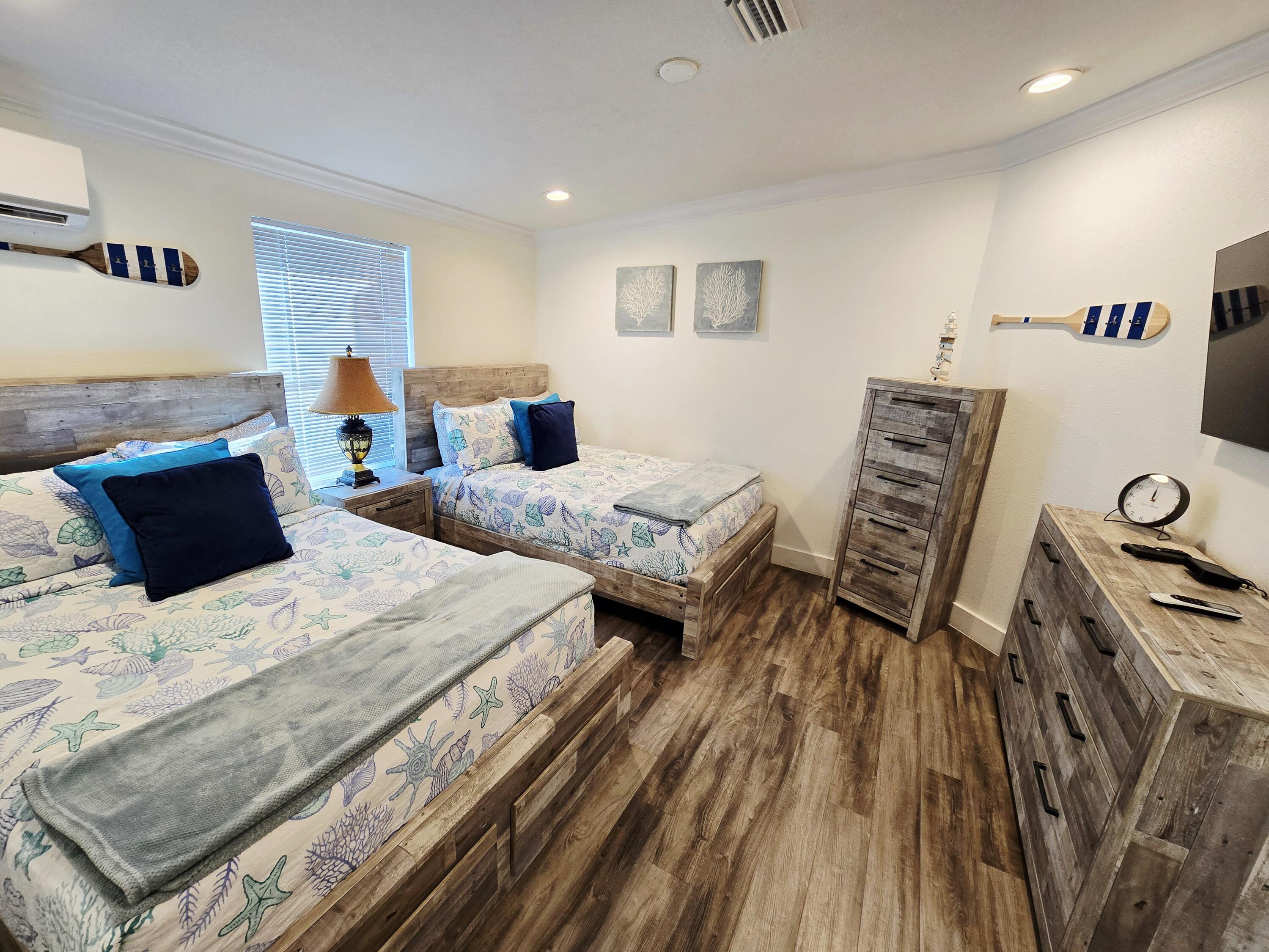 837 91st St Ocean Marathon, FL 33050 - Photo 21 of 27 a bedroom with two beds and a table