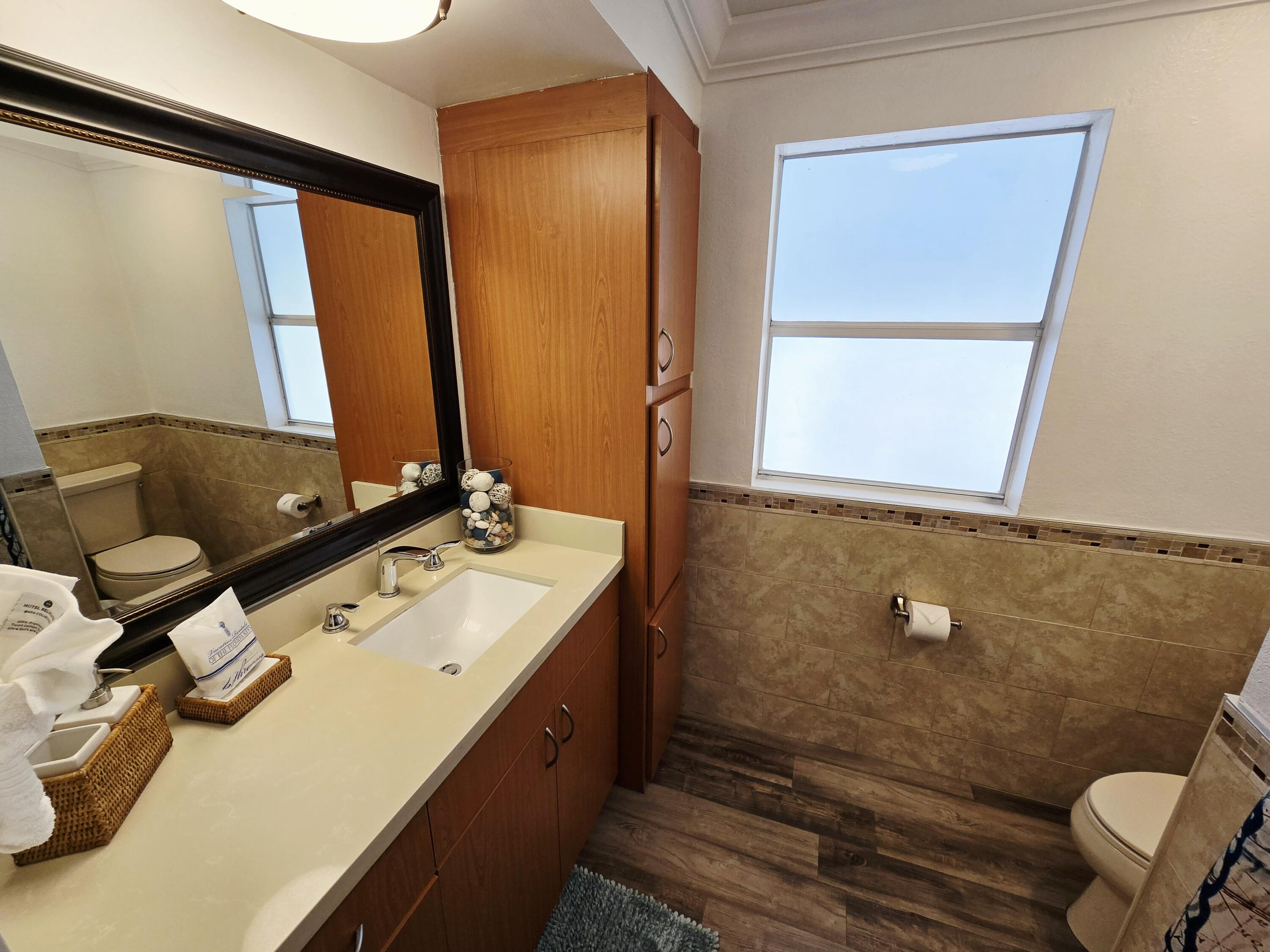 837 91st St Ocean Marathon, FL 33050 - Photo 22 of 27 a bathroom with a sink and a mirror