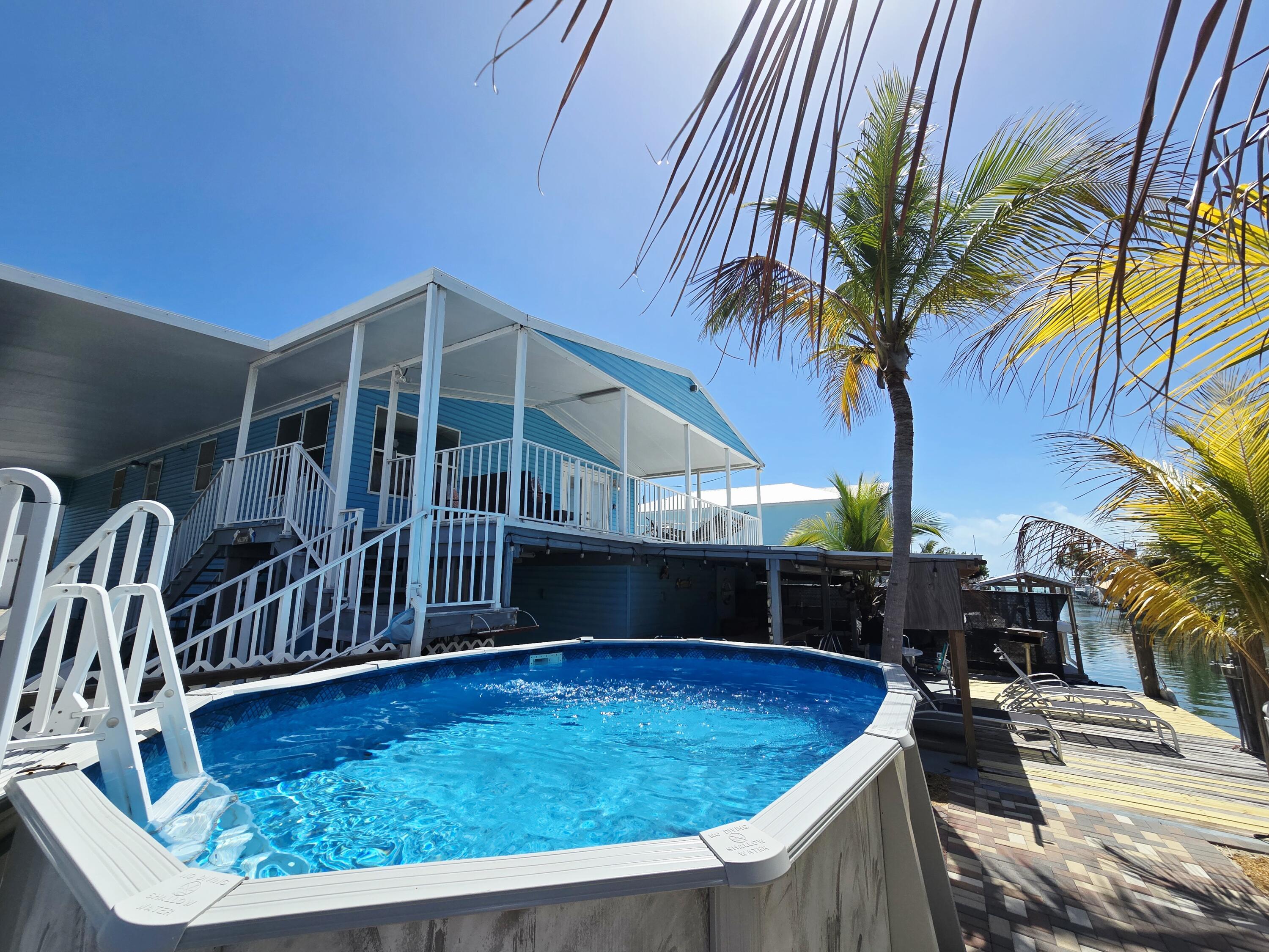 837 91st St Ocean Marathon, FL 33050 - Photo 26 of 27 a view of a backyard with swimming pool
