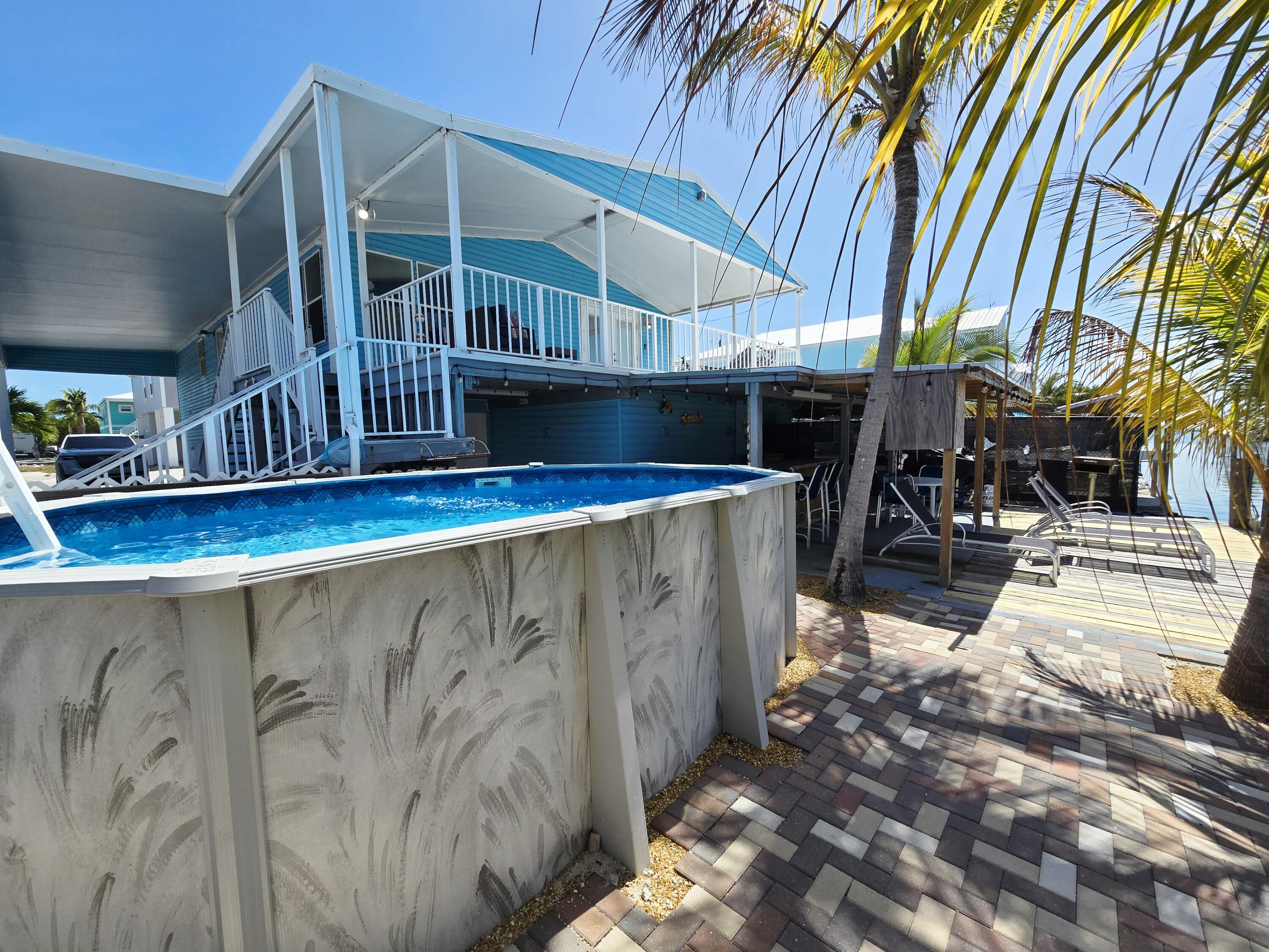 837 91st St Ocean Marathon, FL 33050 - Photo 3 of 27 a view of swimming pool with outdoor seating