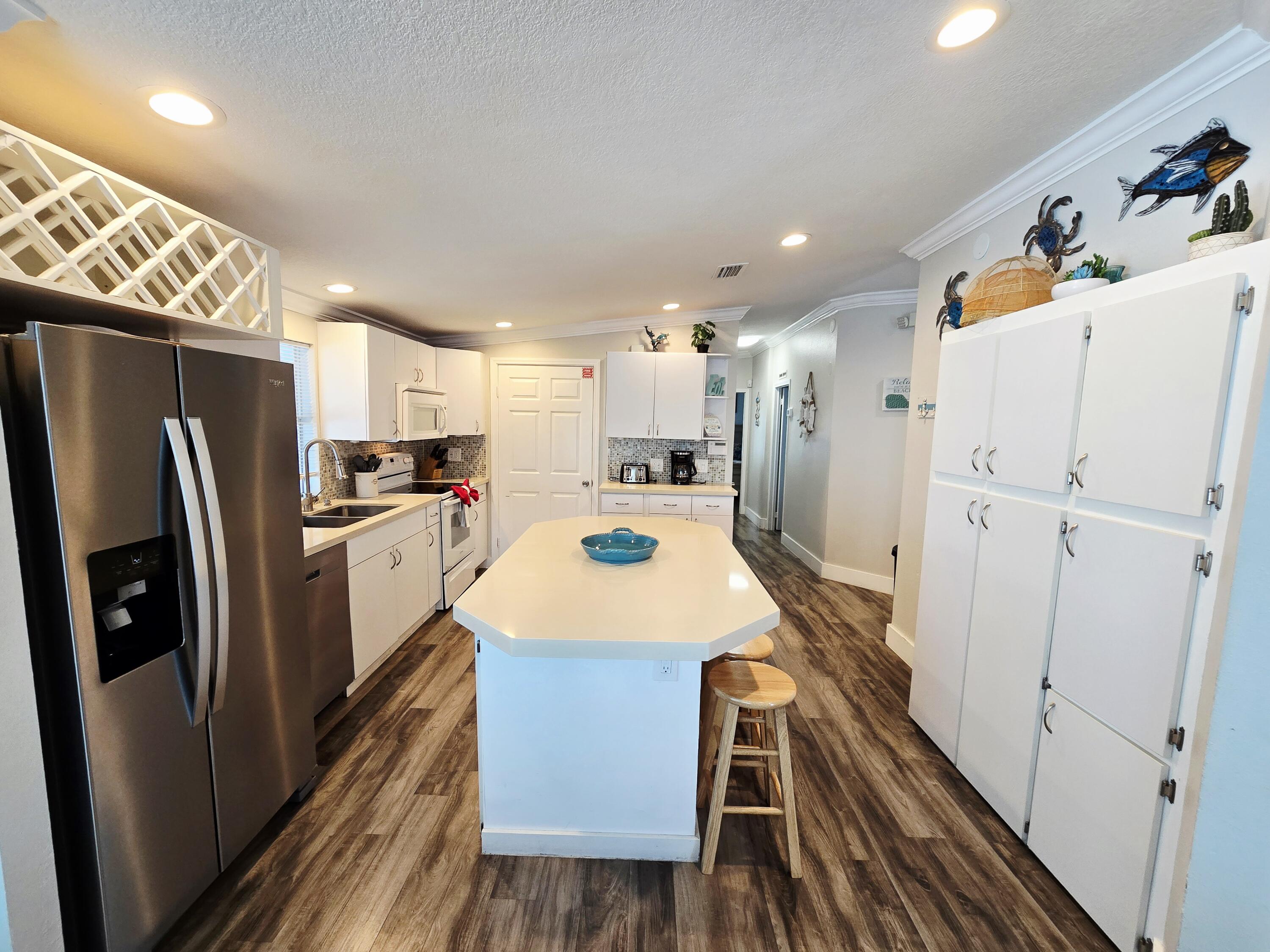 837 91st St Ocean Marathon, FL 33050 - Photo 9 of 27 a kitchen with stainless steel appliances a refrigerator and a stove top oven