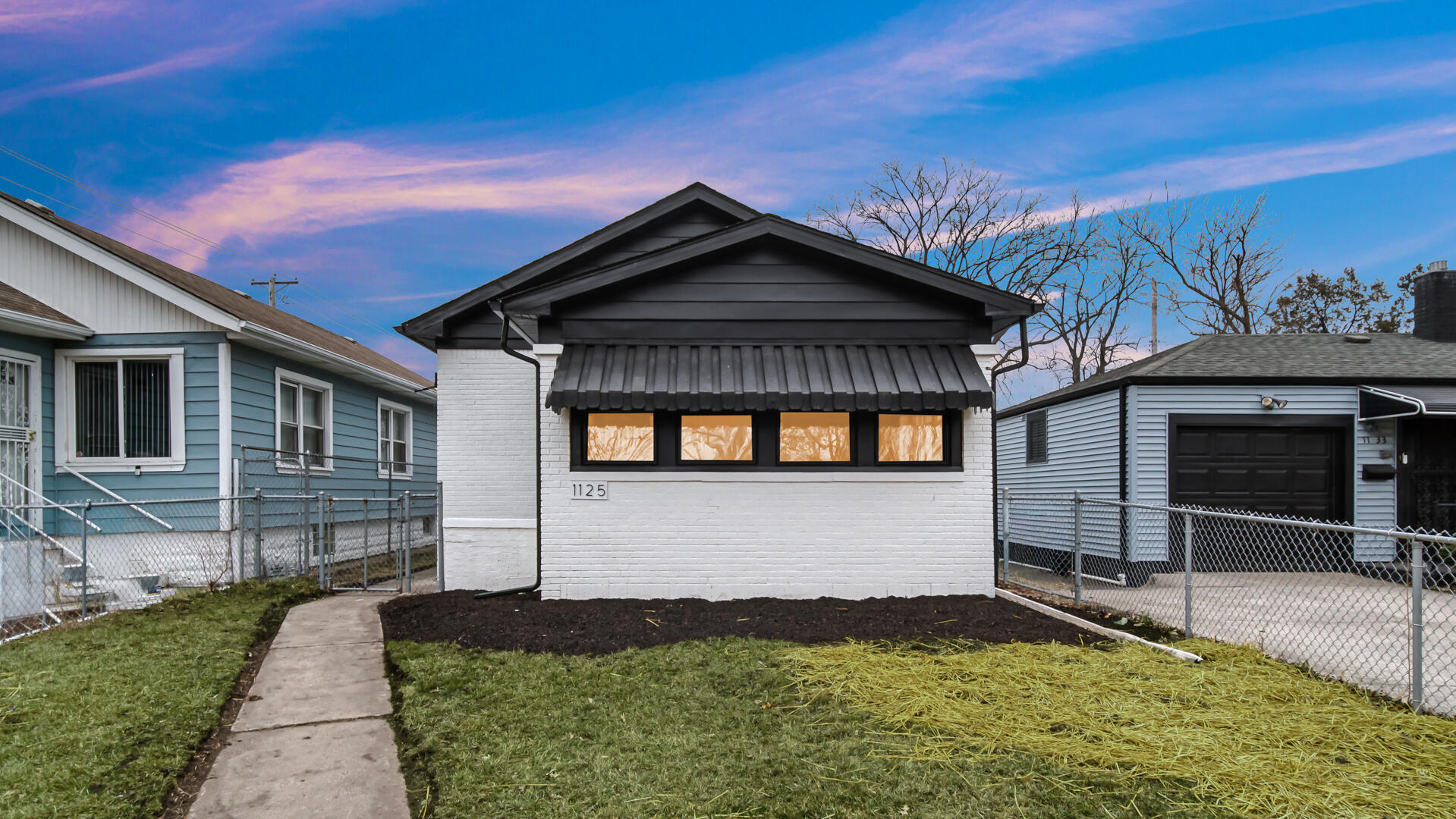 1125 Wallace Street Gary, IN 46404 - Photo 1 of 12 a front view of a house with a yard