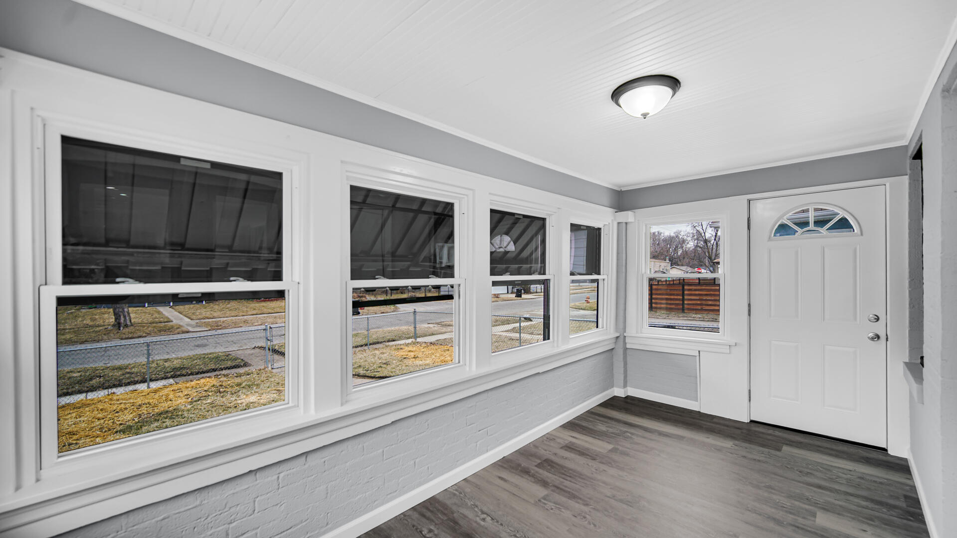 1125 Wallace Street Gary, IN 46404 - Photo 2 of 12 an empty room with wooden floor and windows