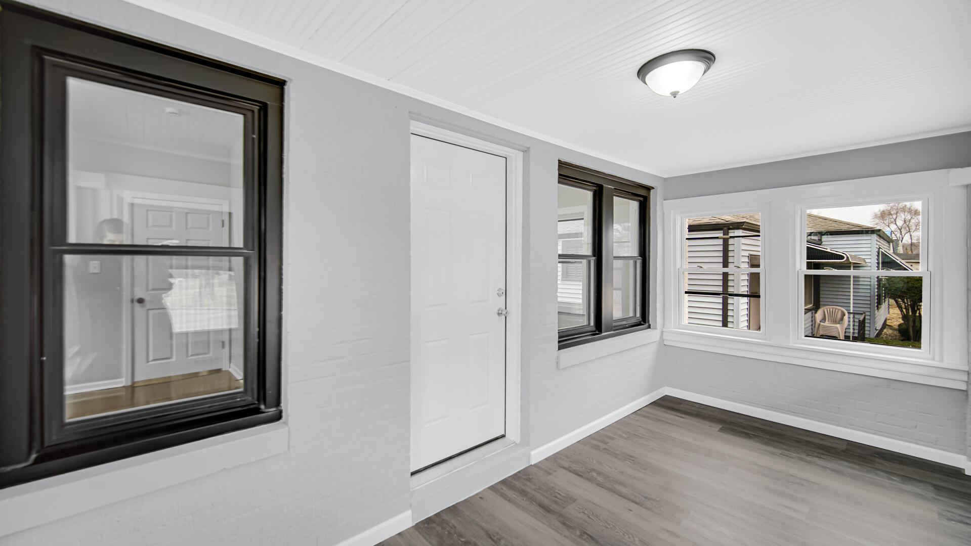 1125 Wallace Street Gary, IN 46404 - Photo 3 of 12 a view of an empty room with wooden floor and a window