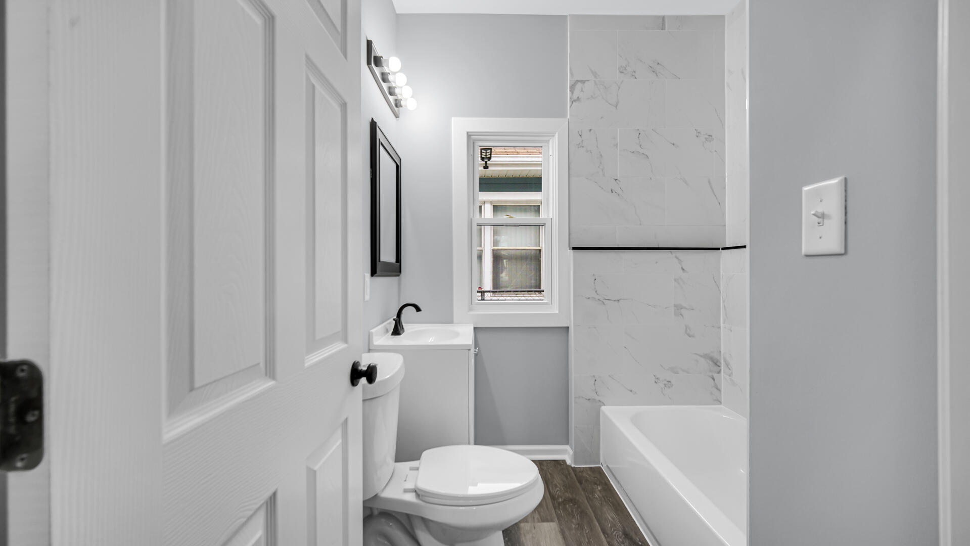 1125 Wallace Street Gary, IN 46404 - Photo 6 of 12 a white toilet sitting next to a bath tub