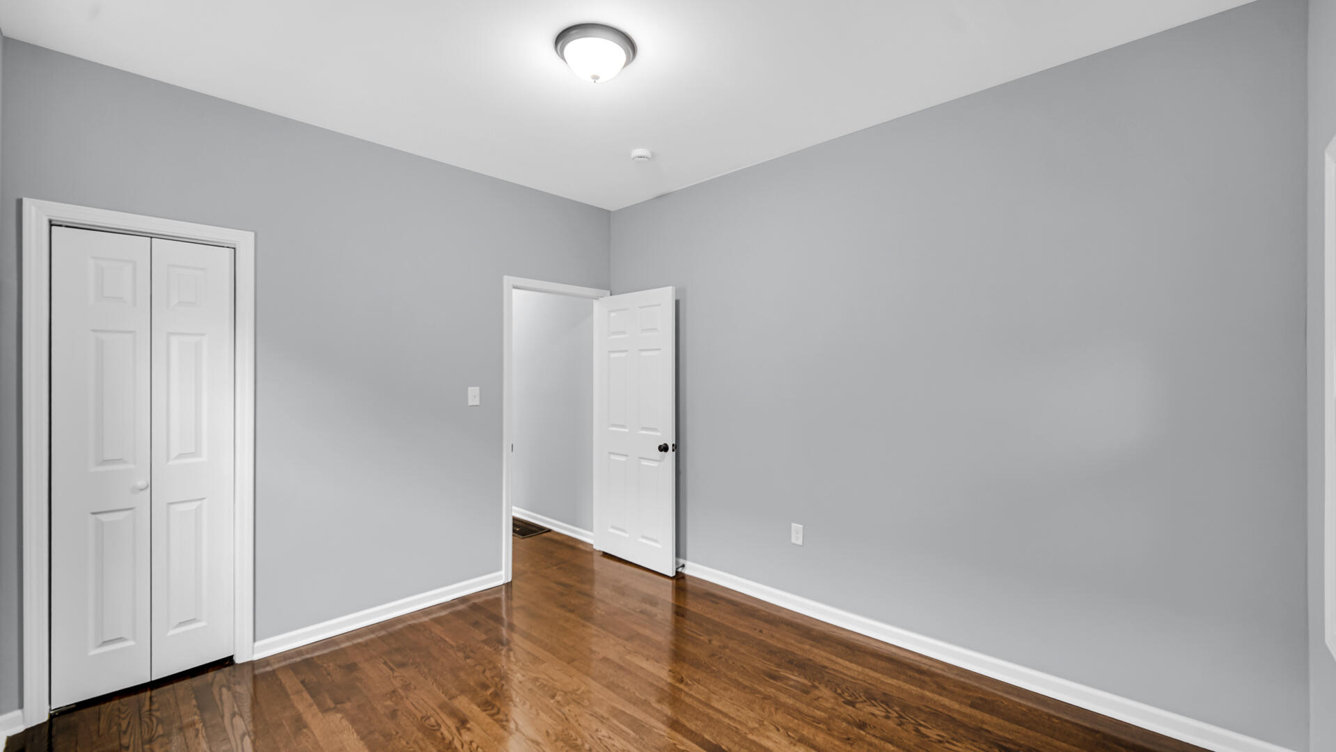 1125 Wallace Street Gary, IN 46404 - Photo 7 of 12 a view of an empty room with wooden floor