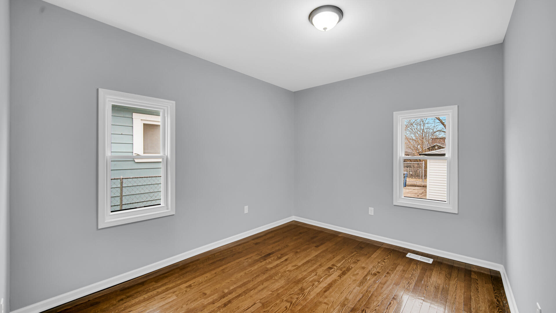 1125 Wallace Street Gary, IN 46404 - Photo 8 of 12 a view of a room with wooden floor and windows