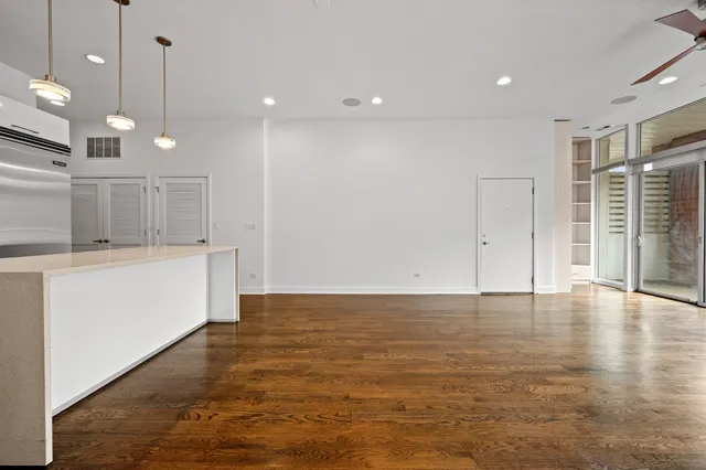 a view of a room with wooden floor and windows