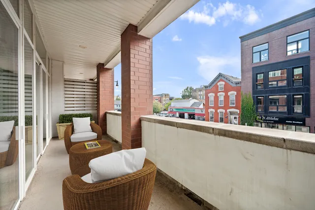 a bedroom with a large bed and a potted plant