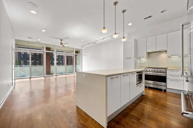 a kitchen with granite countertop a sink stove and cabinets