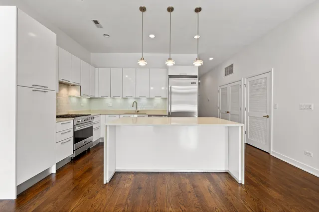 a living room with furniture kitchen and a table