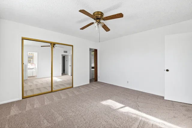 a view of empty room with ceiling fan