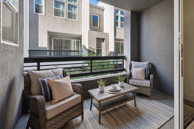 a view of a patio with couches and a potted plant on coffee table with outer view