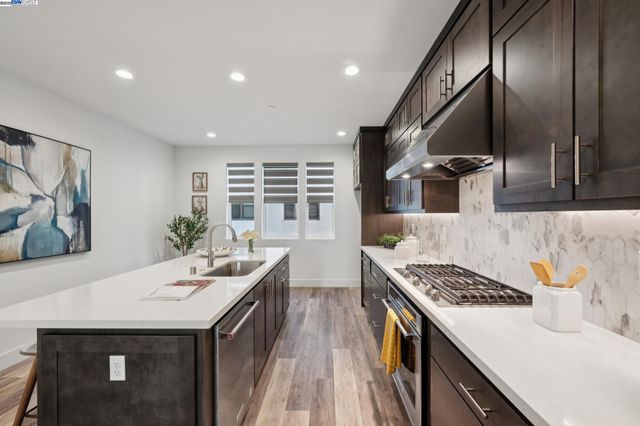 a kitchen with a sink and stove