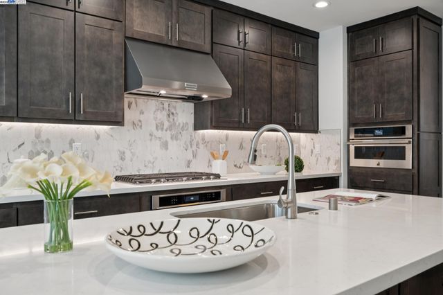 a kitchen with a table and chairs