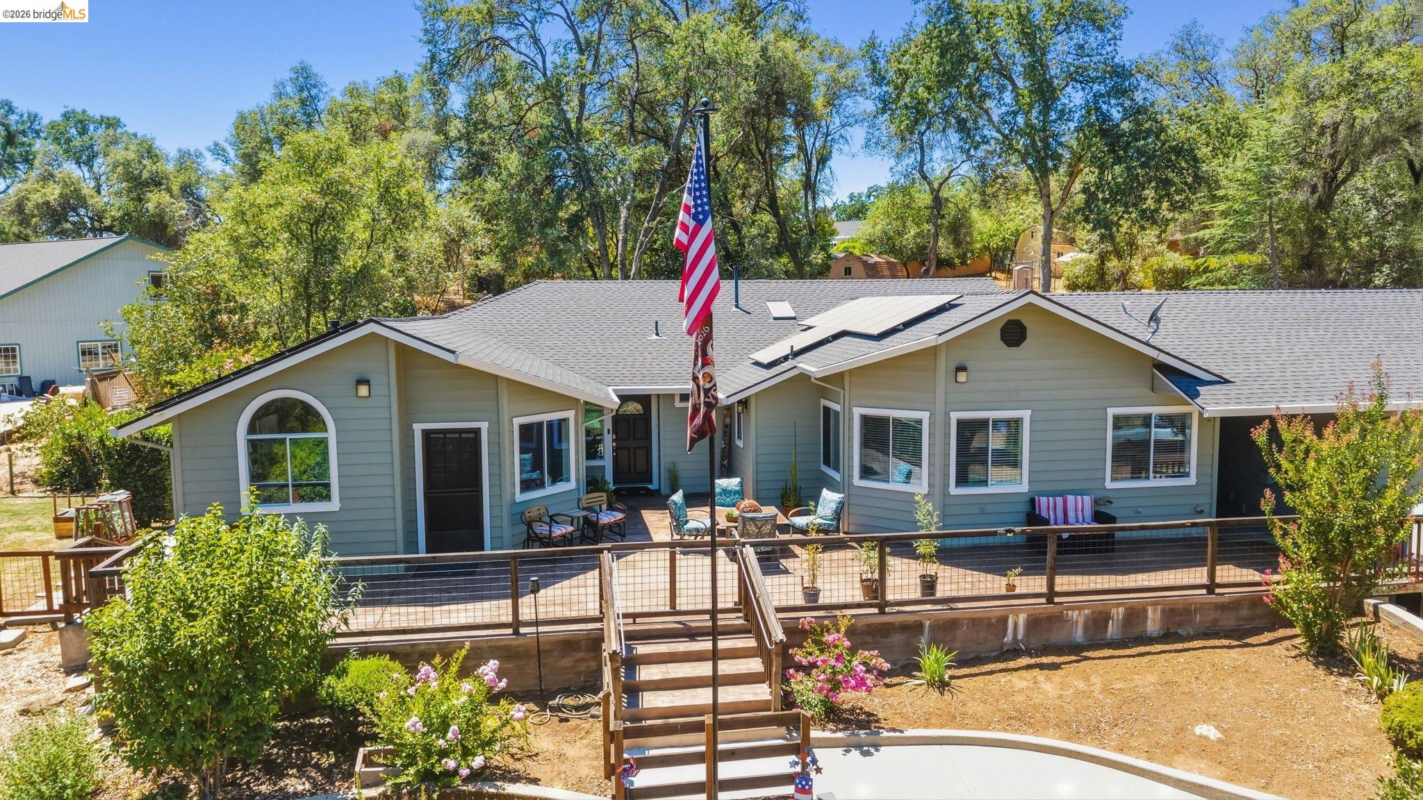 18570 Pradera Real Road Sonora, CA 95370 - Photo 66 of 66 Single-story residence featuring light green siding and a dark gray shingle roof with solar