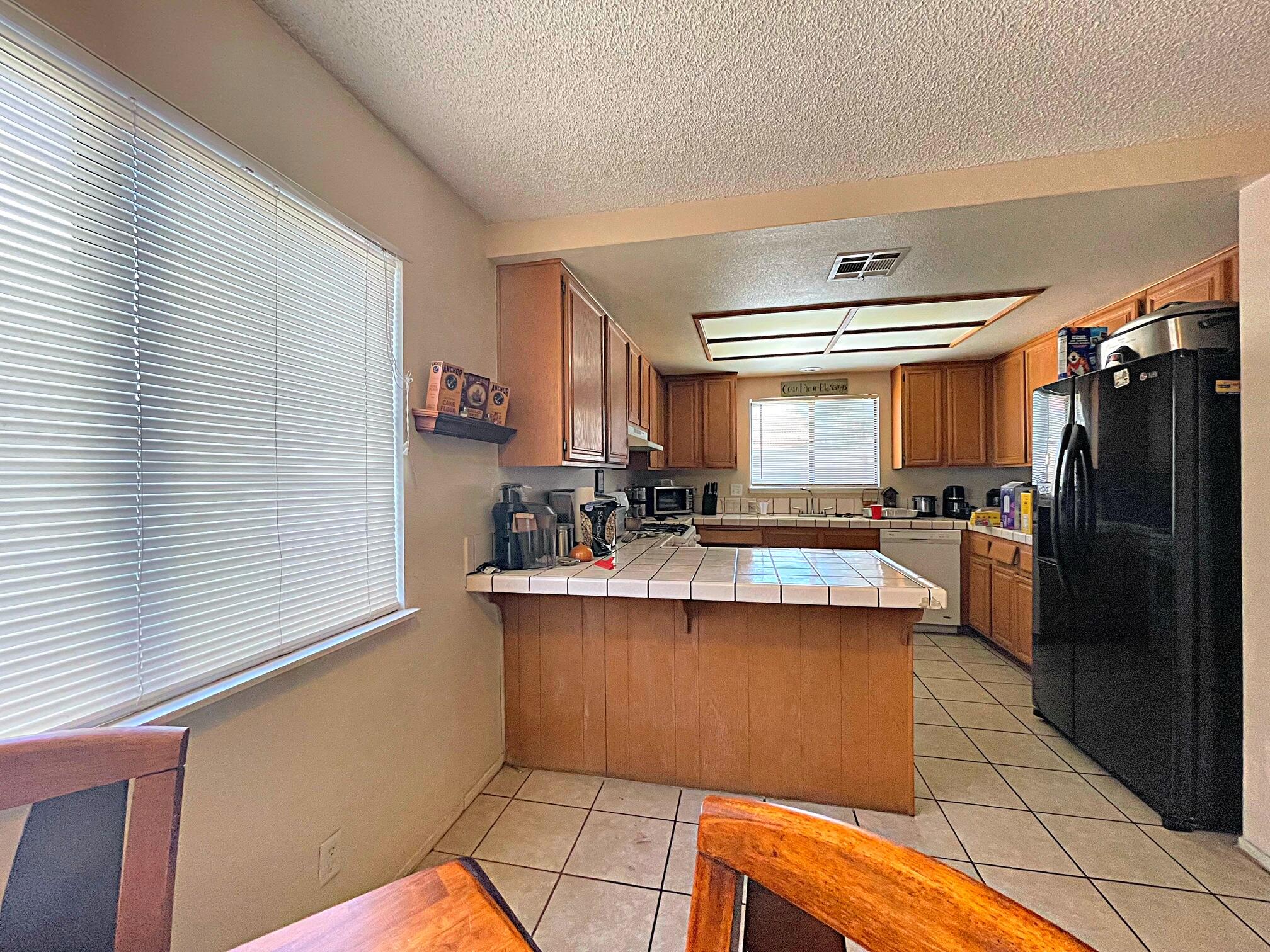 37710 Boxthorn Street Palmdale, CA 93552 - Photo 14 of 43 a kitchen with stainless steel appliances granite countertop a sink stove and refrigerator