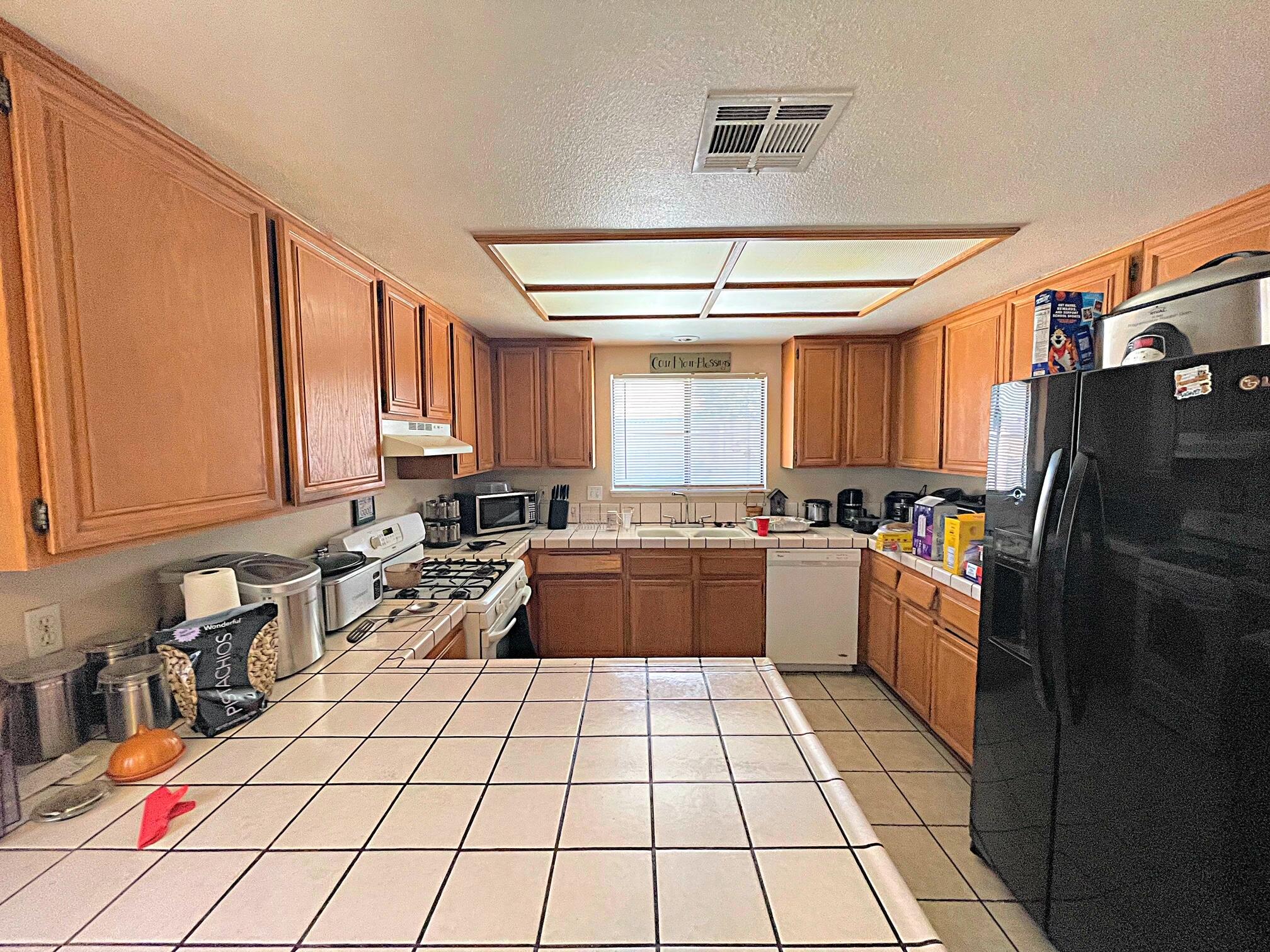 37710 Boxthorn Street Palmdale, CA 93552 - Photo 15 of 43 a kitchen with stainless steel appliances granite countertop a refrigerator and a stove top oven