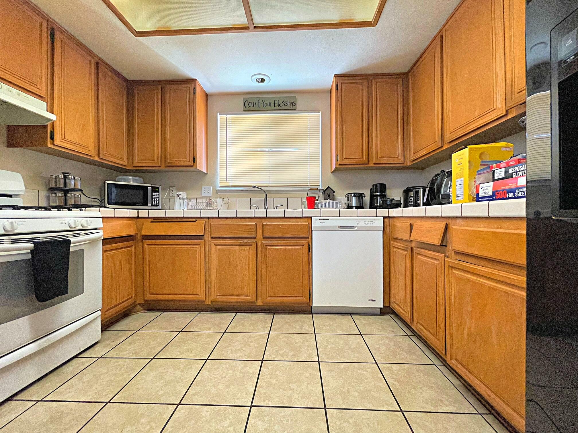 37710 Boxthorn Street Palmdale, CA 93552 - Photo 16 of 43 a kitchen with a stove sink cabinets and window