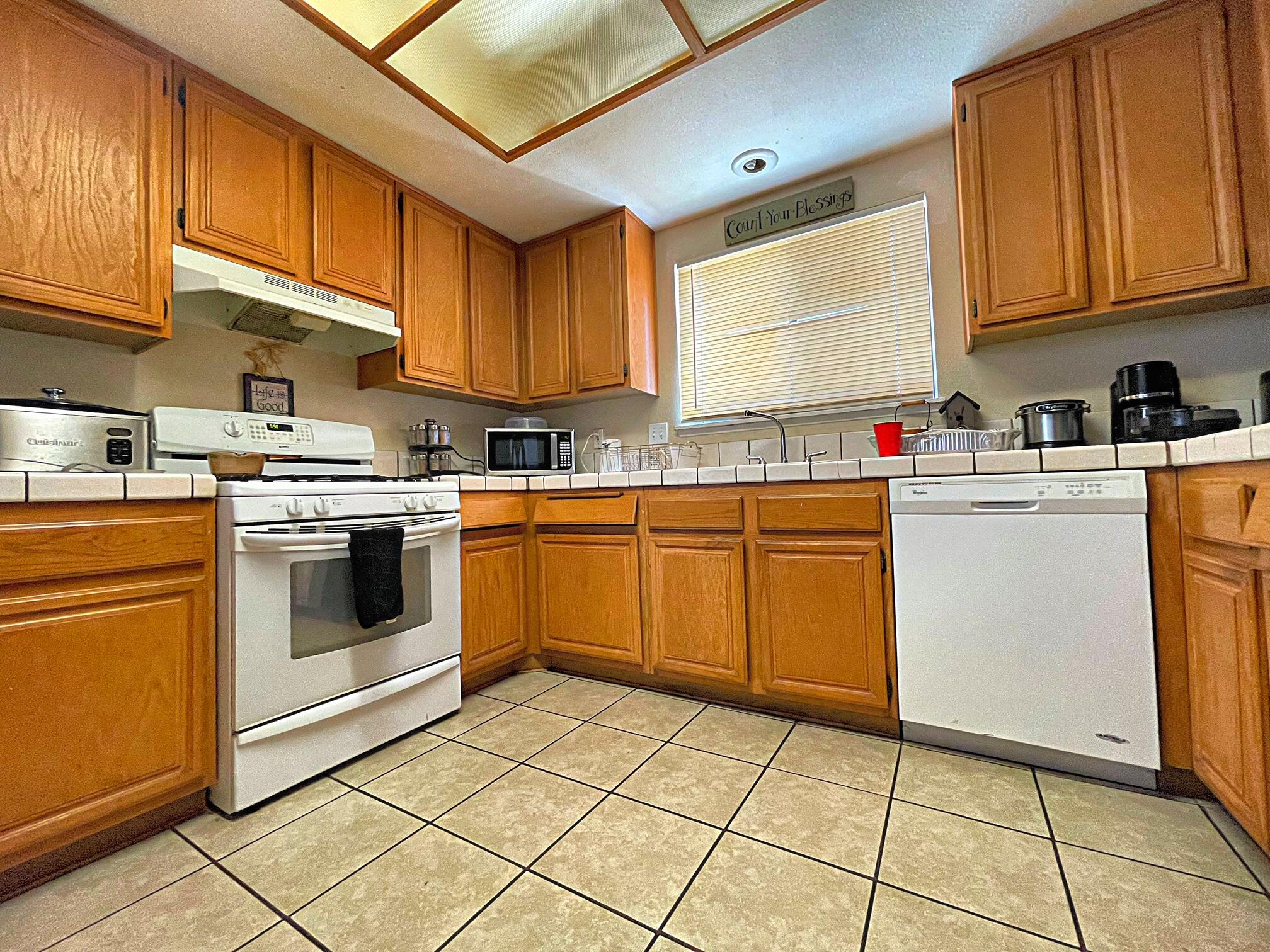 37710 Boxthorn Street Palmdale, CA 93552 - Photo 17 of 43 a kitchen with a stove sink and cabinets
