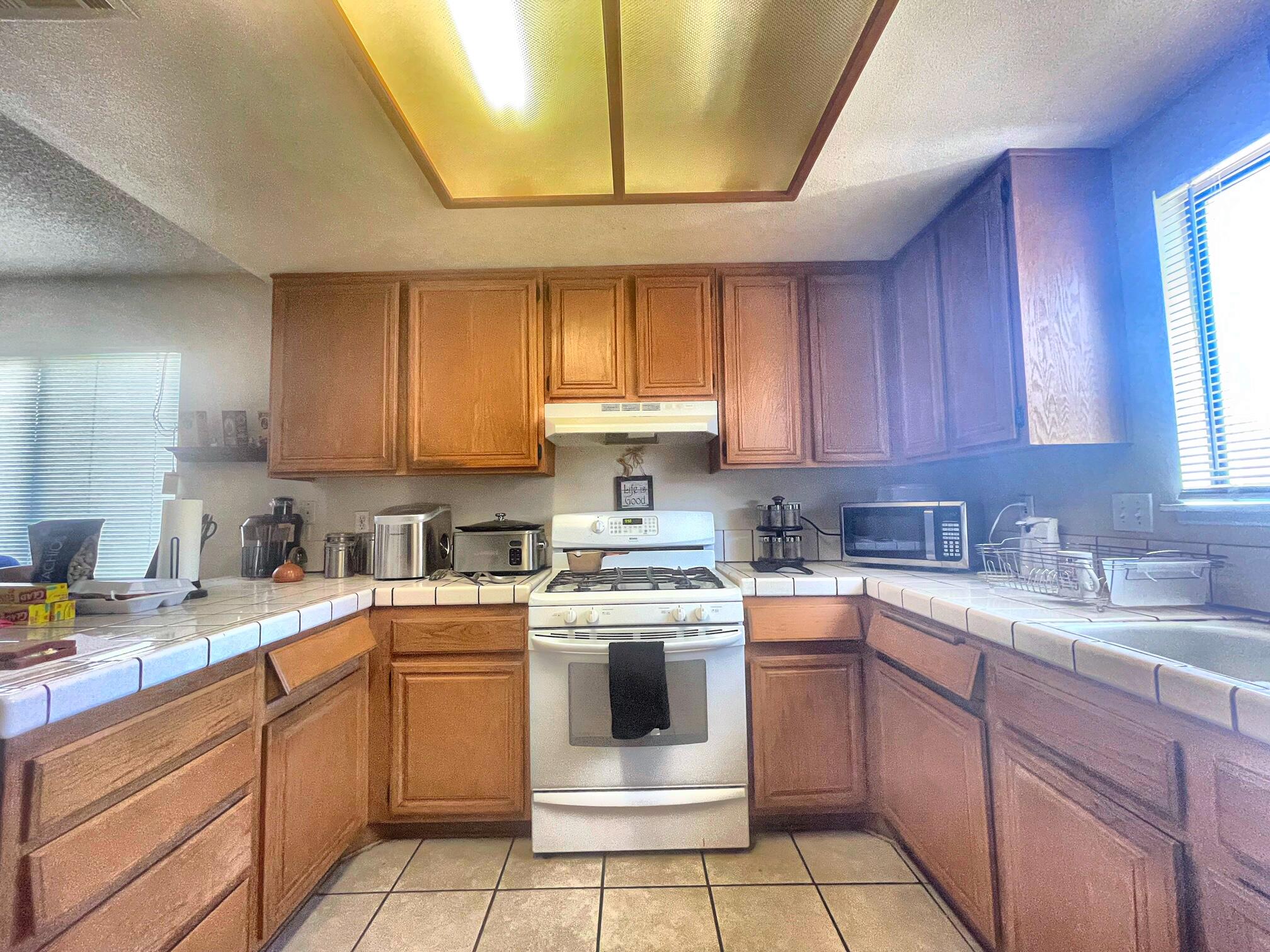 37710 Boxthorn Street Palmdale, CA 93552 - Photo 18 of 43 a kitchen with a stove sink and cabinets