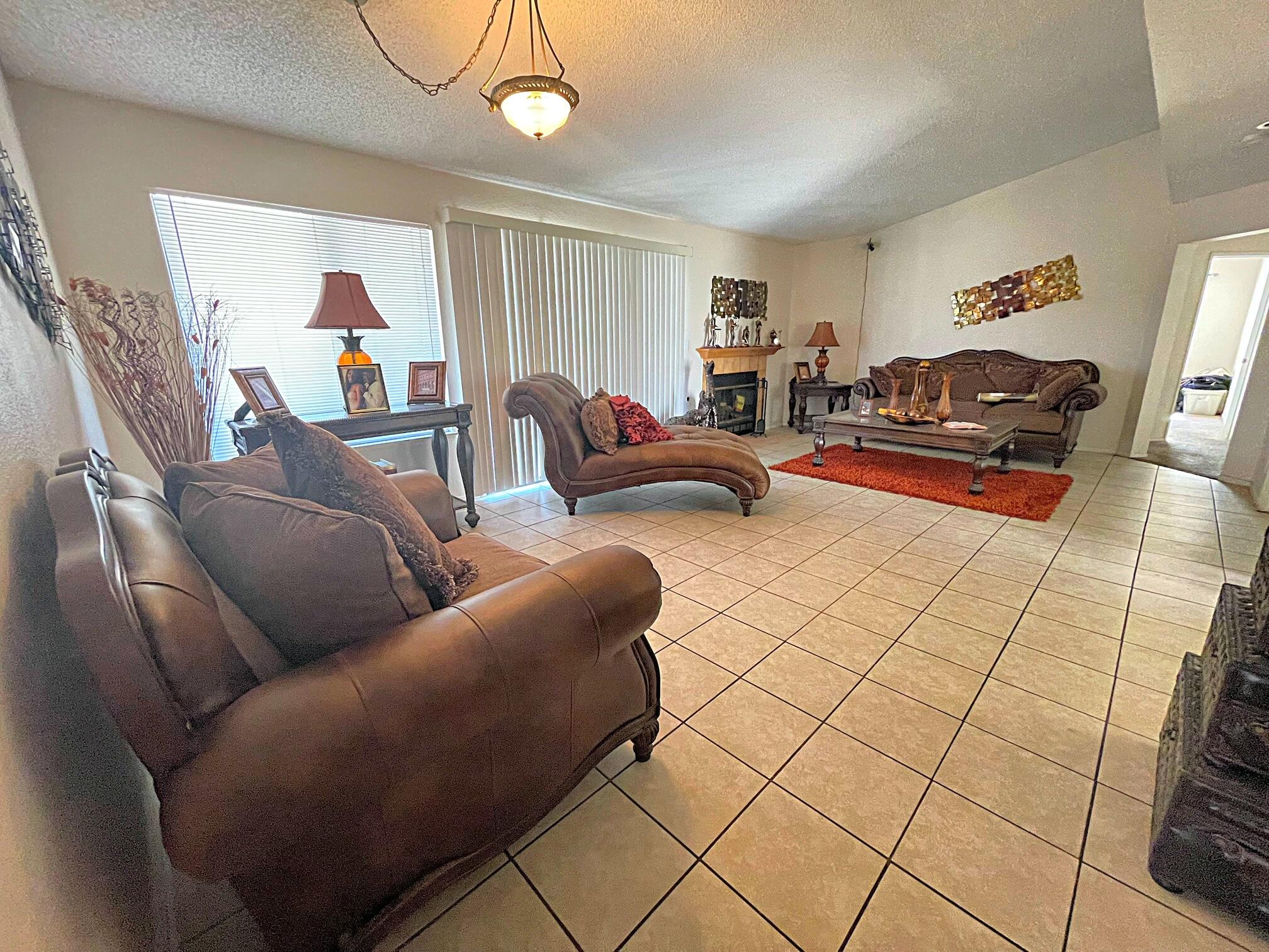 37710 Boxthorn Street Palmdale, CA 93552 - Photo 19 of 43 a living room with furniture and a flat screen tv