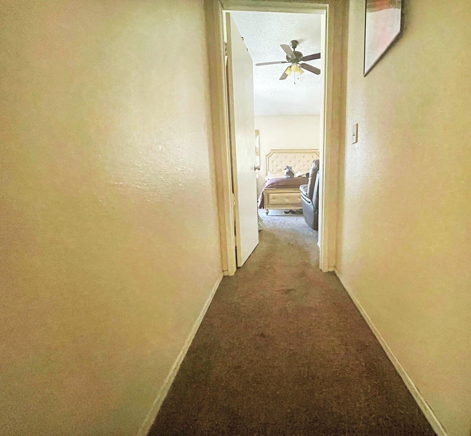 37710 Boxthorn Street Palmdale, CA 93552 - Photo 28 of 43 a view of a hallway with toilet