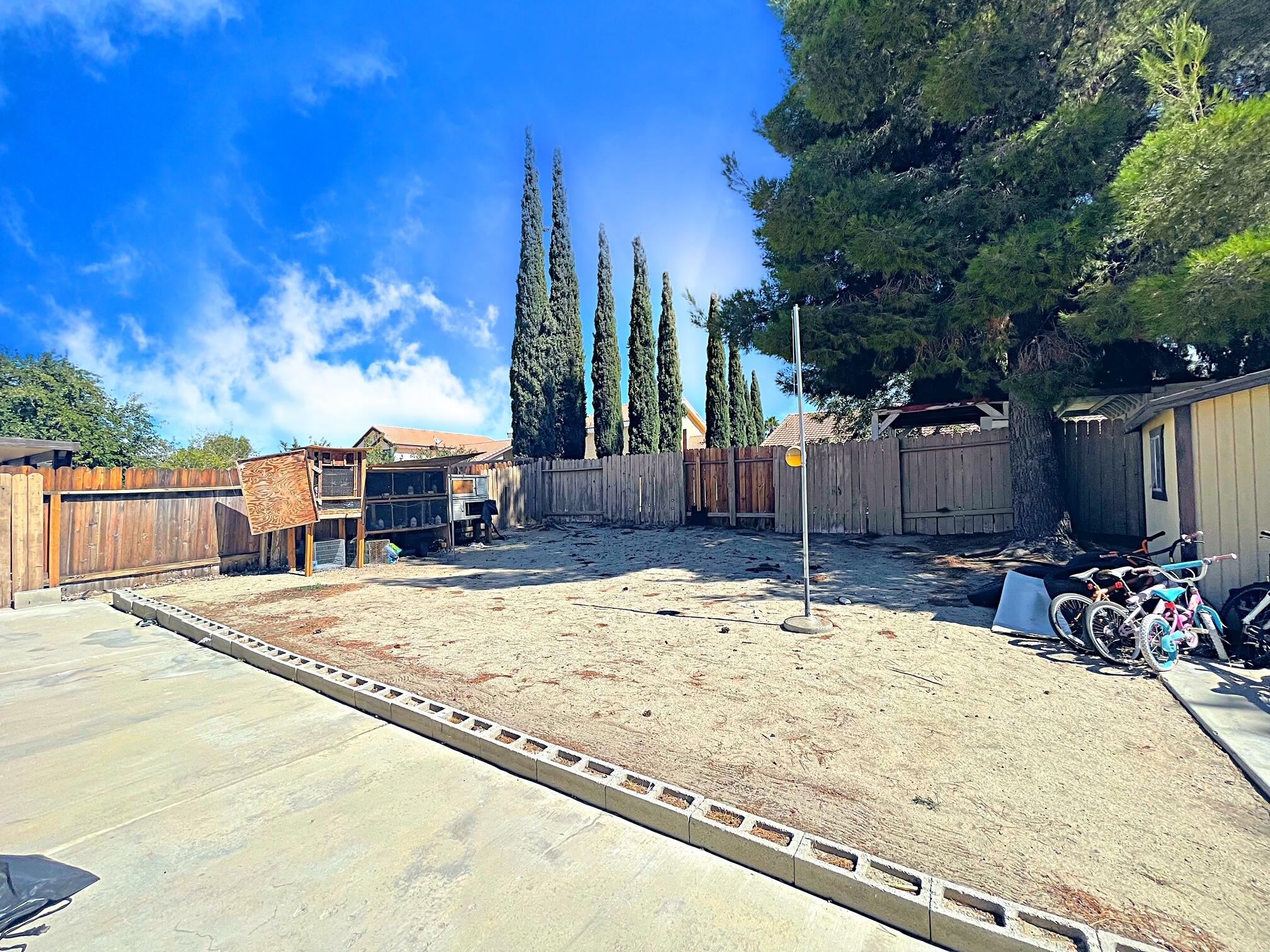 37710 Boxthorn Street Palmdale, CA 93552 - Photo 39 of 43 a swimming pool with outdoor seating and yard