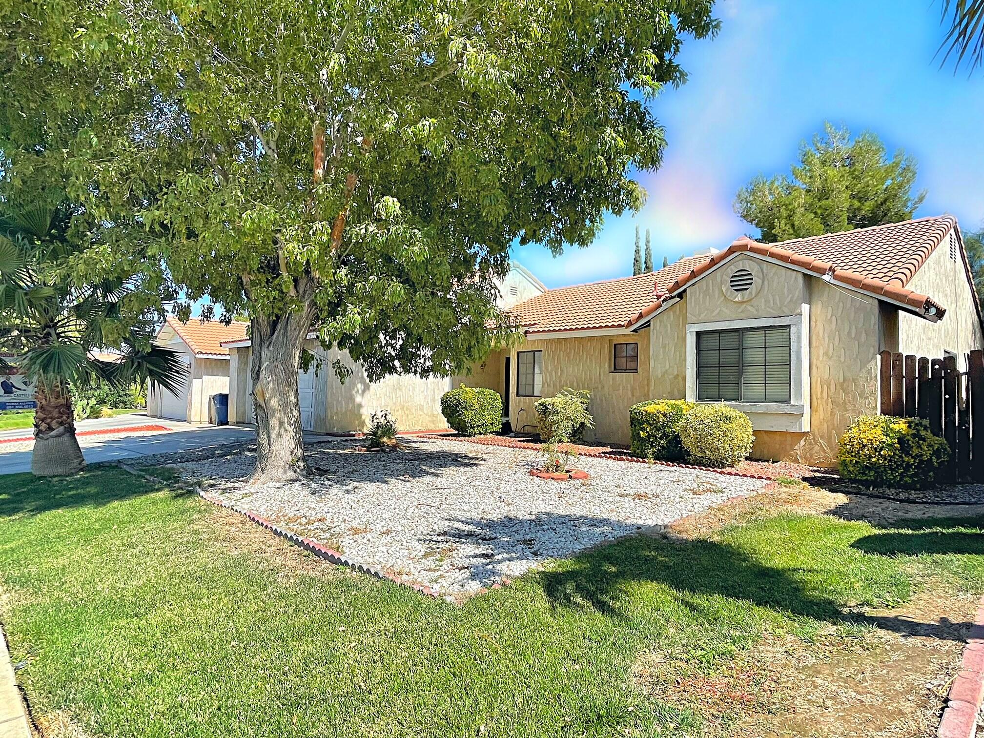 37710 Boxthorn Street Palmdale, CA 93552 - Photo 5 of 43 a front view of a house with a yard and porch