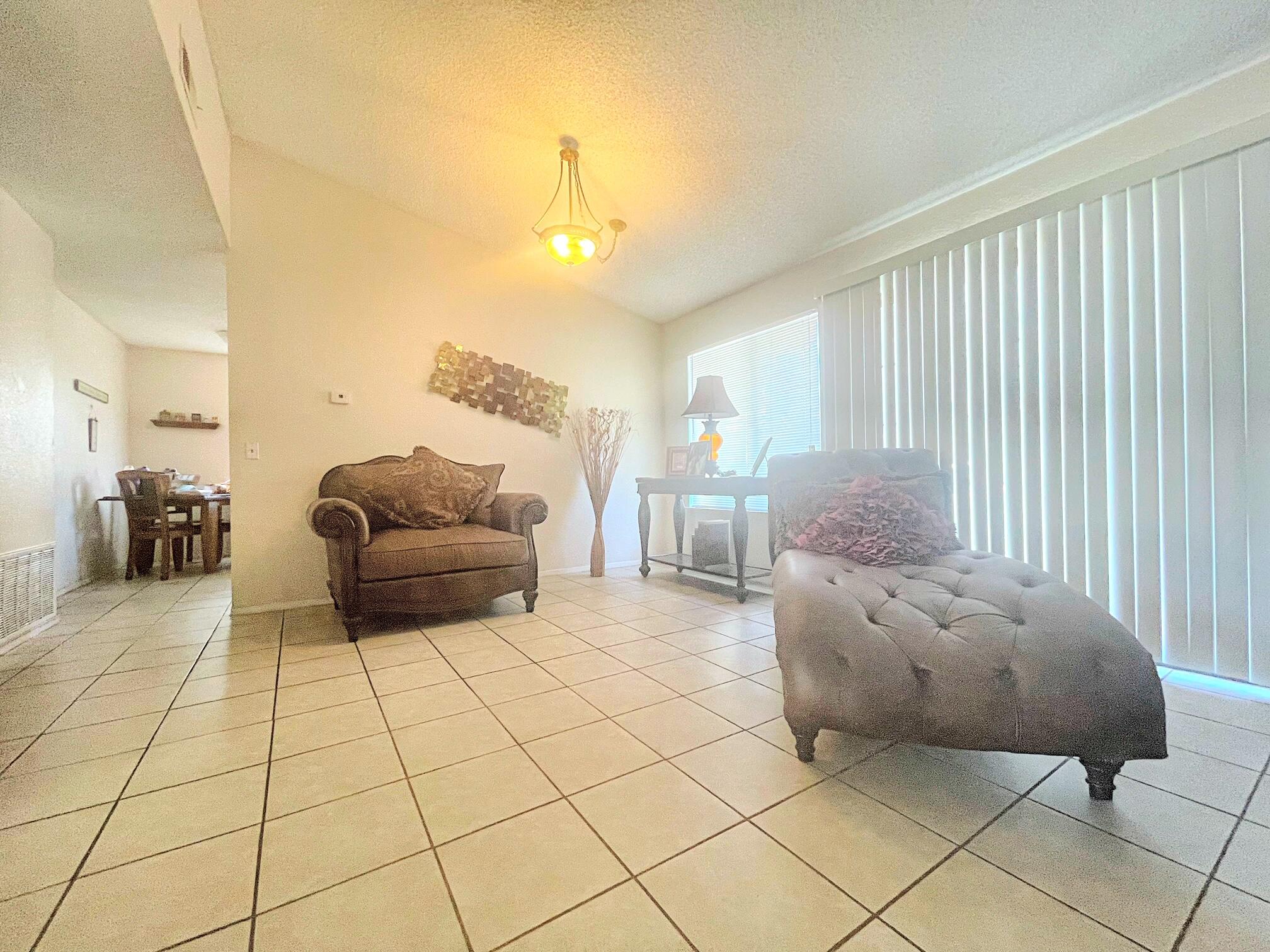 37710 Boxthorn Street Palmdale, CA 93552 - Photo 9 of 43 a living room with furniture and a large window