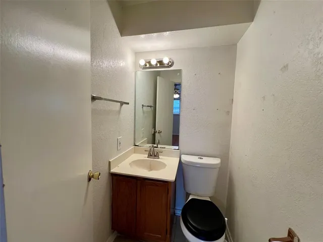 a bathroom with a sink mirror and toilet