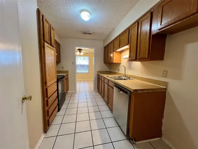 a kitchen with stainless steel appliances a sink stove and cabinets