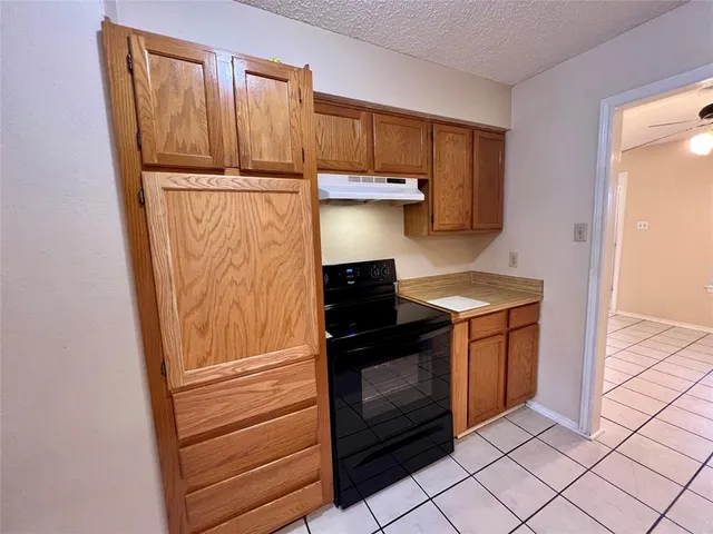 a kitchen with a stove and a refrigerator