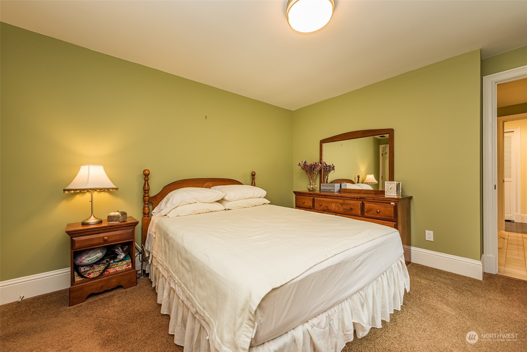 588 Simdars Road Sequim, WA 98382 - Photo 23 of 40 a bedroom with a bed a lamp and a dresser