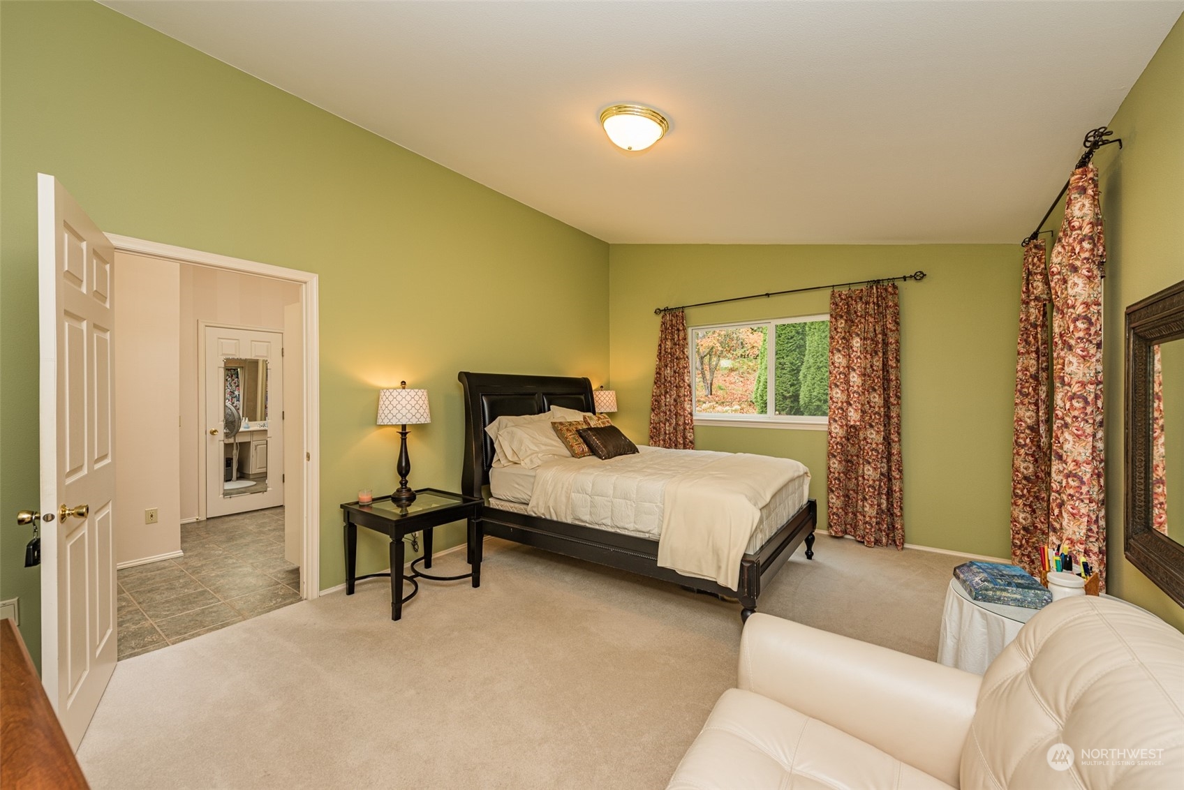 588 Simdars Road Sequim, WA 98382 - Photo 26 of 40 a spacious bedroom with a bed and a couch