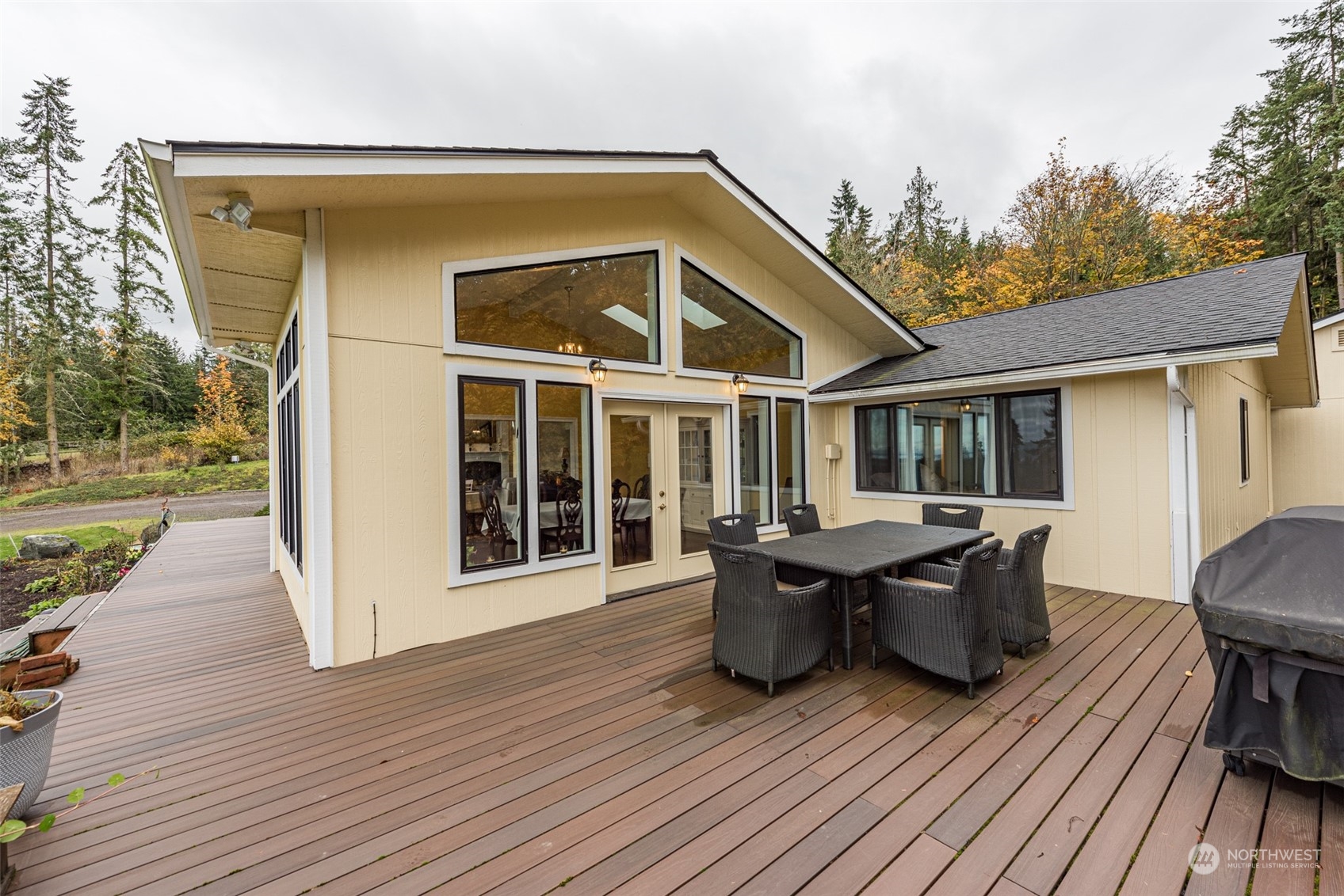 588 Simdars Road Sequim, WA 98382 - Photo 37 of 40 a view of a house and deck with wooden floor and barbeque oven