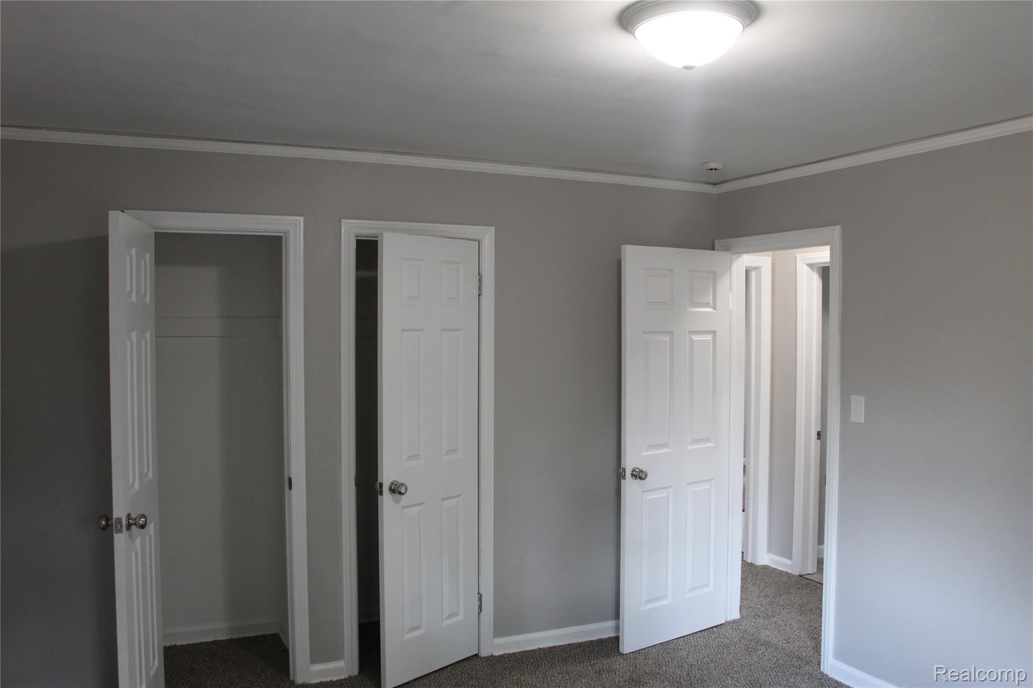 5543 Balfour Road Detroit, MI 48224 - Photo 45 of 54 Interior room featuring light gray walls, white trim, and dark carpeting