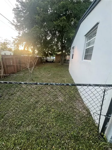 a view of a yard with a tree