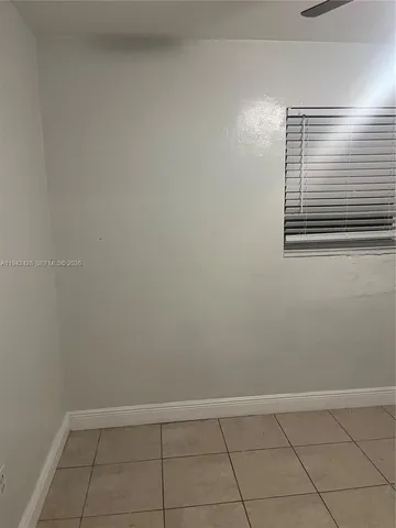 a kitchen with granite countertop a stove a sink and a refrigerator