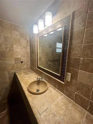 a bathroom with a sink a vanity and a mirror