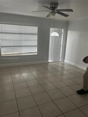 a view of a livingroom with a furniture and chandelier fan