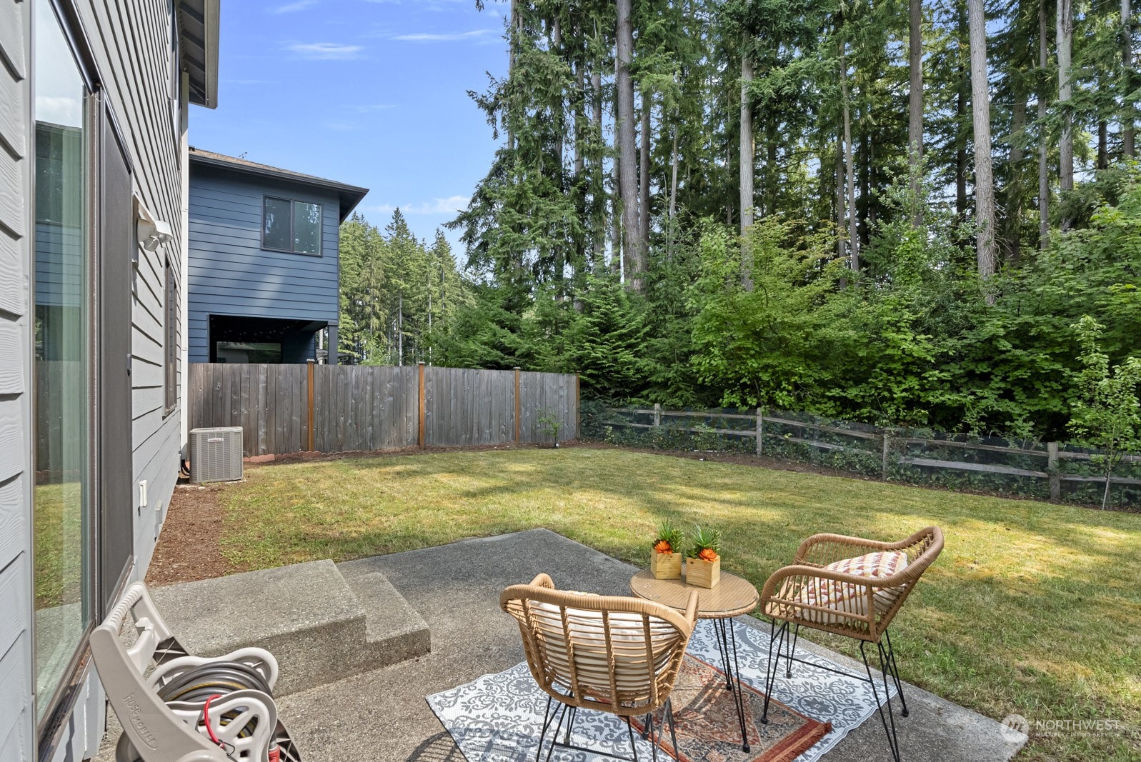 4404 181st Street Southeast Bothell, WA 98012 - Photo 18 of 37 a swimming pool with some potted plants and large tree