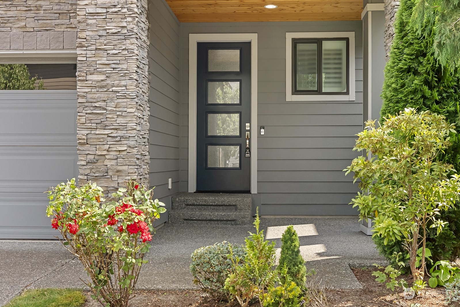 4404 181st Street Southeast Bothell, WA 98012 - Photo 2 of 37 a front view of a house with a lot of flowers
