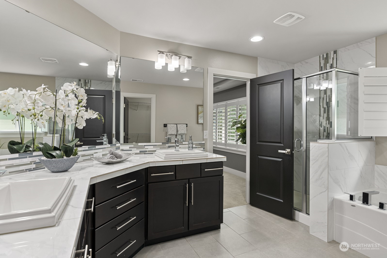4404 181st Street Southeast Bothell, WA 98012 - Photo 23 of 37 a bathroom with a granite countertop sink a large mirror and a shower