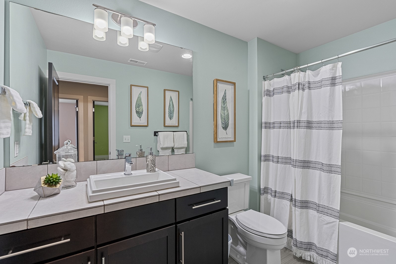 4404 181st Street Southeast Bothell, WA 98012 - Photo 30 of 37 a bathroom with a granite countertop sink a toilet a mirror a vanity and shower