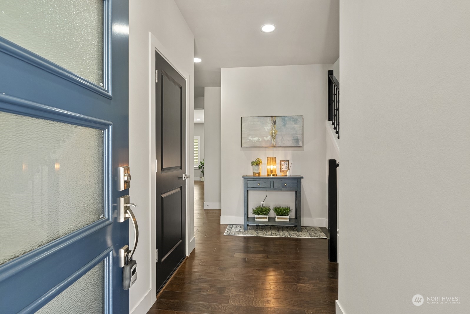 4404 181st Street Southeast Bothell, WA 98012 - Photo 4 of 37 a view of a hallway with wooden floor and a living room